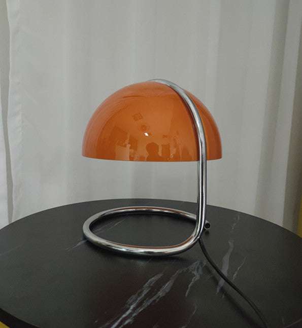 Table Lamp Retro Metal Bedroom Bedside Lamp Mushroom Lamp with orange dome shade and chrome curved base on black marble table