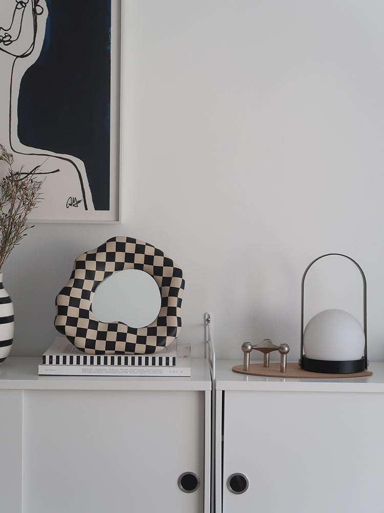 Modern checkerboard makeup mirror on bedroom desk

